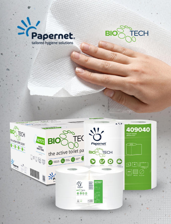 Eine Hand wischt mit einem weißen Papierhandtuch eine gesprenkelte Oberfläche ab. Im Vordergrund sind Verpackungen und Rollen von Papernet Bio Tech-Toilettenpapier zu sehen, auf denen das Papernet-Logo und Produktangaben zu sehen sind.