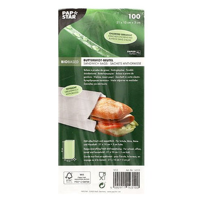 Opakowanie 100 PAPSTAR torebek na kanapki odpornych na tłuszcz (21x10x3 cm, białe) od PAPSTAR GmbH jest w opakowaniu zgrzewanym z nadrukowanymi szczegółami produktu i pokazuje kanapkę wewnątrz białych torebek odpornych na tłuszcz.