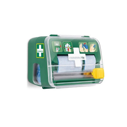 Pianka opatrunkowa Cederroth 2-w-1 od Orkla Wound Care AB to zielono-biały zestaw ścienny z przezroczystą pokrywą, który zawiera materiały opatrunkowe (6 sztuk) i posiada ilustrowaną instrukcję na przedniej stronie.