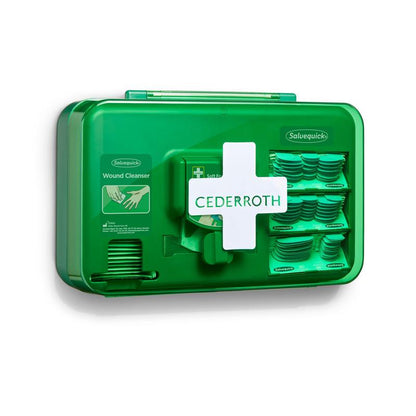 Niebieski dozownik do opatrunków Orkla Wound Care AB (1 opakowanie), montowany na ścianie, zawiera przegrody z chusteczkami do oczyszczania ran i taśmami klejącymi. Urządzenie jest oznaczone białym symbolem krzyża dla łatwej identyfikacji.