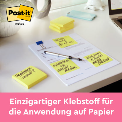 Stos karteczek samoprzylepnych Post-it® Notes firmy 3M, żółte (76 mm x 127 mm, 100 arkuszy/blok), leży na biurku obok notatek. Tekst na dole: "Mocny klej - pewnie trzyma się na papierze. 12 bloków na opakowanie, opakowanie kartonowe, 100% PEFC."