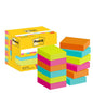 Żółte pudełko z karteczkami samoprzylepnymi Post-it® (3M Deutschland GmbH, Poptimistic Collection, 38 x 51 mm, 100 kartek/blok, 12 bloków/opakowanie) stoi obok stosów kwadratowych karteczek samoprzylepnych w jaskrawych kolorach żółtym, różowym, niebieskim, pomarańczowym i zielonym.