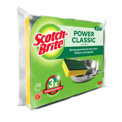 Przedstawione jest opakowanie 3M Deutschland GmbH Scotch-Brite® Classic gąbki do czyszczenia z dwiema gąbkami. Na przeważnie zielonym opakowaniu znajduje się gąbka i metalowy garnek, z angielskim i niemieckim tekstem.