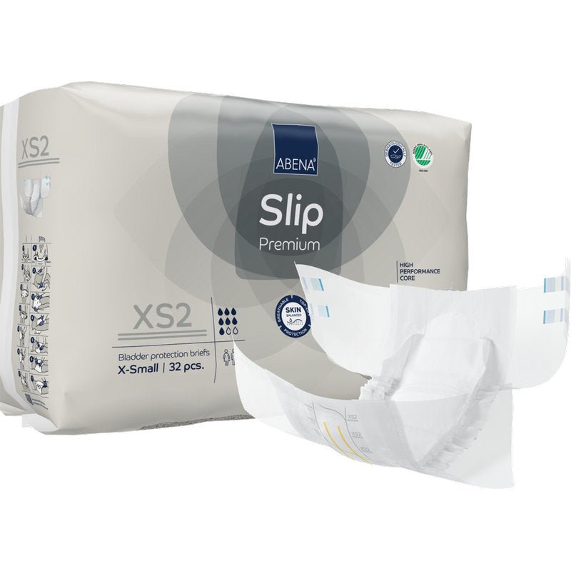 Opakowanie ABENA Slip Premium od Abena Re-Seller GmbH, rozmiar X-Small, z 32 slipami ochronnymi na pęcherz. Jeden slip jest przedstawiony z przodu jako rozłożony, pokazując jego design dla skutecznej ochrony przed nietrzymaniem moczu.