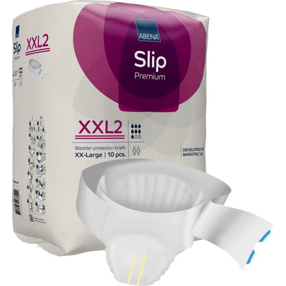Opakowanie ABENA Slip Premium firmy Abena Re-Seller GmbH jest wystawione, częściowo rozpakowany slip leży przed nim. Fioletowo-białe opakowanie podkreśla rozmiar XX-Large, 10 sztuk, i niezawodną opiekę inkontynencyjną.
