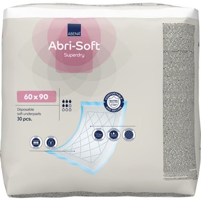 Eine Packung mit 30 Stück Abena Re-Seller GmbH Einweg-Unterlage, Abri-Soft Superdry, Blau (60 x 90 cm) enthält eine bebilderte Verpackung mit den Produktmerkmalen und einem Schema der Lagen der Unterlage.