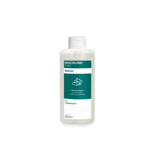 Biała plastikowa butelka płynu myjącego Dr. Schumacher Descolind Pure Wash (500 ml) firmy Dr. Schumacher GmbH, opatrzona zielono-białą etykietą, znajduje się na prostym, jasnoszarym tle. Ten płyn myjący o pH neutralnym dla skóry i bezzapachowy jest idealny dla skóry wrażliwej.