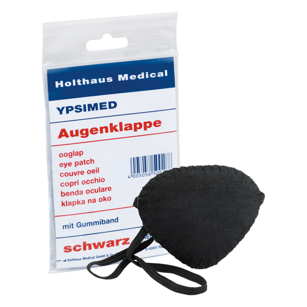 Wystawiono opaskę na oko Holthaus Ypsimed z gumką, wykonaną z czarnego materiału. Obok znajduje się plastikowe opakowanie z napisem „Holthaus Medical GmbH & Co. KG”, „YPSIMED” i „opaska na oko” w kilku językach, które wskazuje na użycie jako medyczne narzędzie do ochrony oczu.