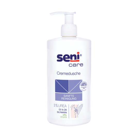 Ta Seni Płyn do kąpieli Care Cremedusche firmy TZMO Deutschland GmbH, 500 ml, zawiera 3% mocznika, sylimarynę oraz ma wegańską formułę. Biała butelka jest wyposażona w pompkę i opatrzona niebieskim napisem „DELIKATNE OCZYSZCZANIE”, co sprawia, że produkt idealnie nadaje się do skóry suchej.