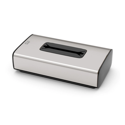 Dozownik chusteczek kosmetycznych Tork 460013 z kolekcji Image Line F1 od TORK – Essity Professional Hygiene Germany GmbH to pudełko na chusteczki ze stali nierdzewnej z prostokątnym otworem na górze. Prezentuje się w designie ze stali nierdzewnej, ma czarne lakierowane krawędzie i minimalistyczny styl, który jest idealny do pojedynczego pobierania arkuszy.