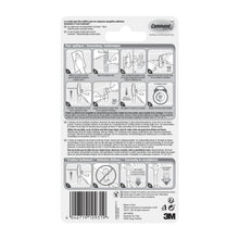 Die Rückseite einer Command™ Bad Medium Designer-Haken, 17081B von 3M Deutschland GmbH-Verpackung zeigt illustrierte Auf- und Abbauschritte, mehrsprachigen Text, Sicherheitswarnungen und einen Barcode am unteren Rand.